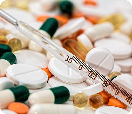 An image of pills, tablets and an syringe